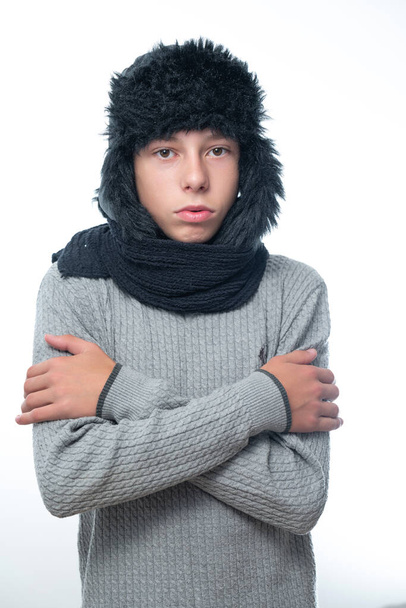 Portrait of upset guy in winter hat and scarf, cold winter and crisis time, ear hat and cold. - Photo, Image
