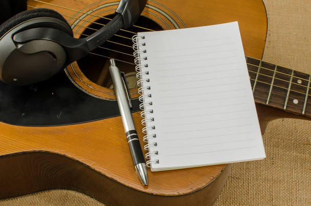 blank paper with pen on old acoustic guitar - Photo, image