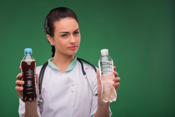 Woman doctor with bottle of mineral water - Foto, imagen