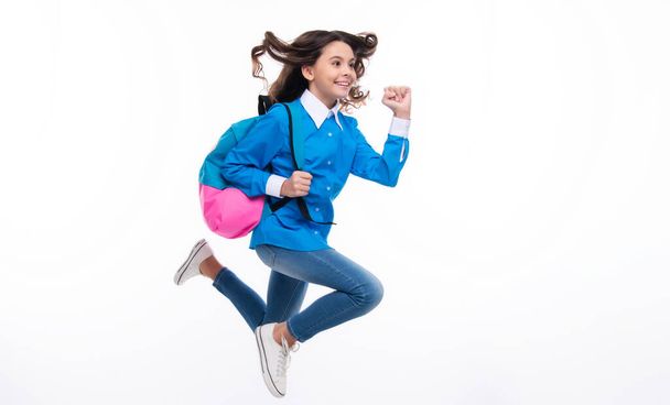 School girl with backpack. Teenager student, isolated background. Learning and knowledge. Go study. Run and jump. Children education concept - Фото, зображення