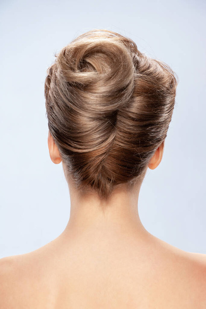 Back view of young woman. Nude young white woman. Blonde hair. Stylish hairstyle. Isolated on a gray background - Φωτογραφία, εικόνα