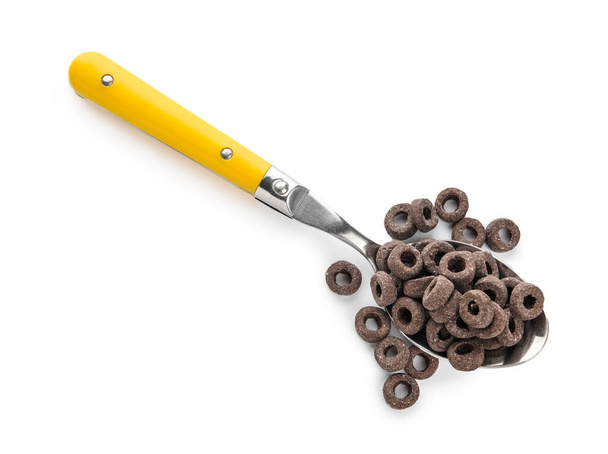 Spoon with black cereal rings on white background - Photo, Image