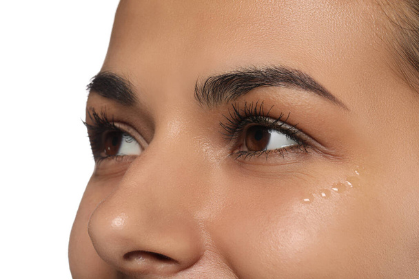 Woman with eye cream on white background, closeup. Skin care - Photo, image