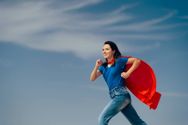 Superhero Woman Wearing Red Cape Running to Save the Day - Photo, image