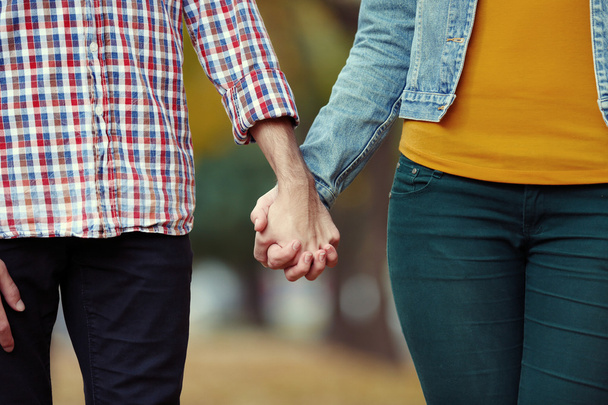Loving couple holding hands outdoors - Foto, afbeelding