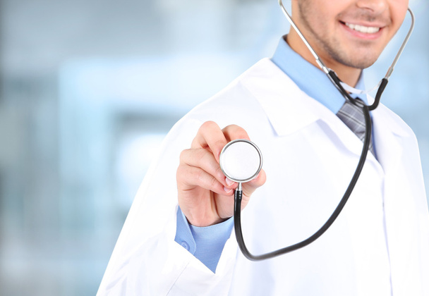 Male Doctor on hospital background - Foto, Bild