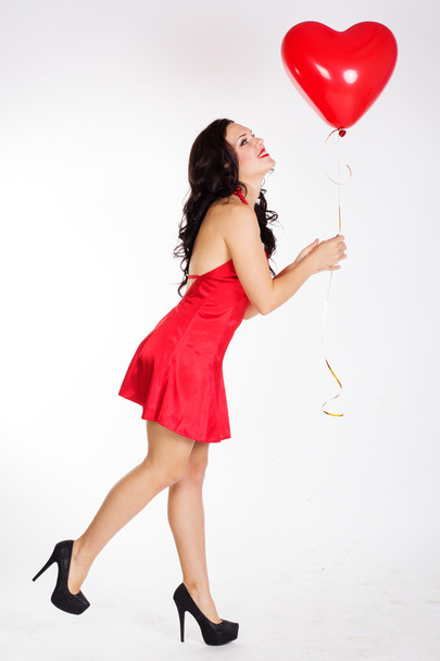 Sexy brunette with red ballon - Foto, afbeelding