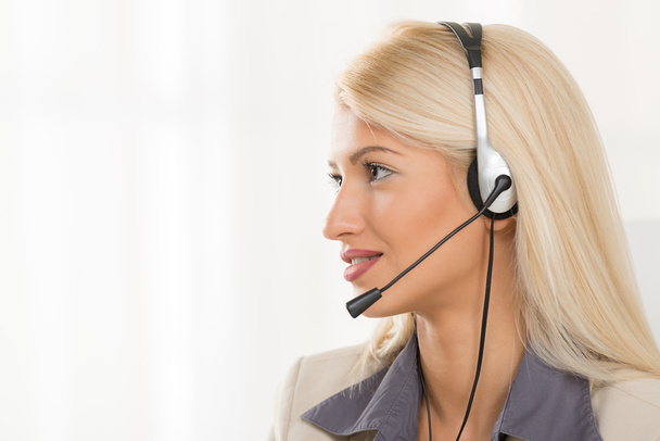 Young Blond Woman With A Headset - Photo, Image