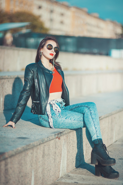 Young fashion beautiful girl in leather jacket and sunglasses  - 写真・画像