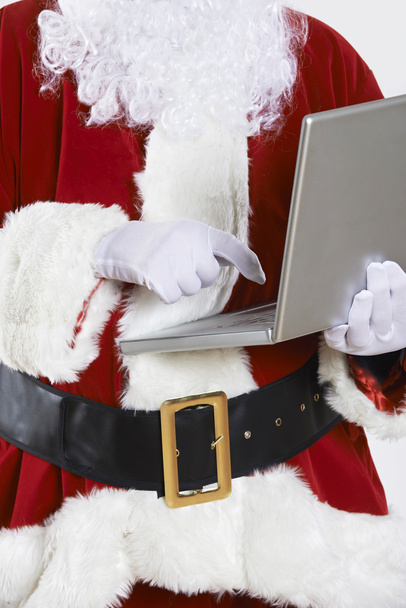 Santa Claus Using Laptop On White Background - Foto, afbeelding