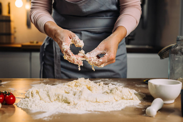 woman making dough in home kitchen - Fotó, kép