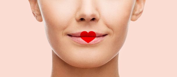 close up of woman face with heart shape on lips - Fotoğraf, Görsel