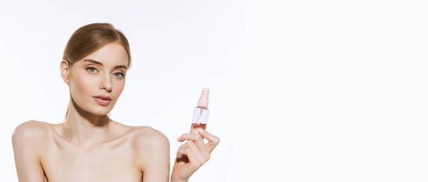 Fresh and healthy. Charming pretty young woman with light makeup holding spray bottle and looking at camera isolated over white background. Concept of beauty, skincare, cosmetology, spa. Flyer for ad - Φωτογραφία, εικόνα