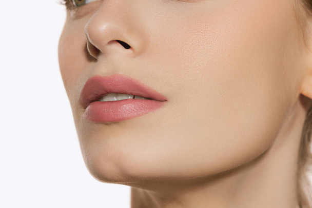 Closeup female lips, cheeks and nose isolated over white studio background. Natural beauty. Concept of natural beauty, cosmetology, skincare, cosmetics, plastic surgery, ad - Φωτογραφία, εικόνα