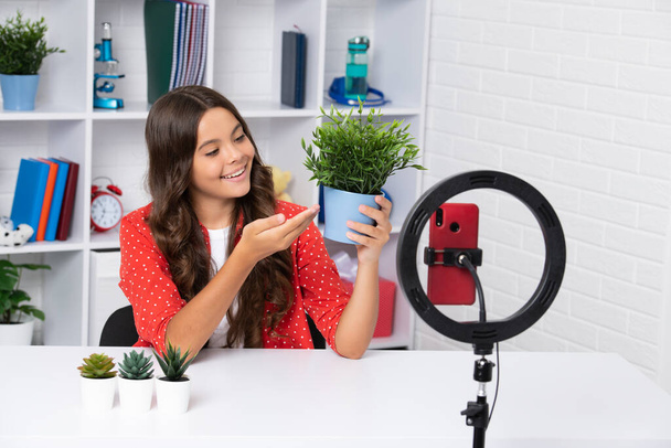 Teen girl speaking in front of camera for vlog. Teenager working as blogger, recording video blog. Happy girl face, positive and smiling emotions - Photo, Image
