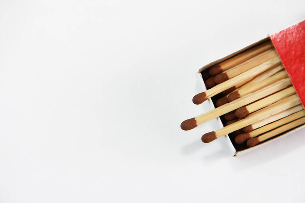 yellow wooden matches with a sulfur head in a cardboard box on a white background - Photo, Image