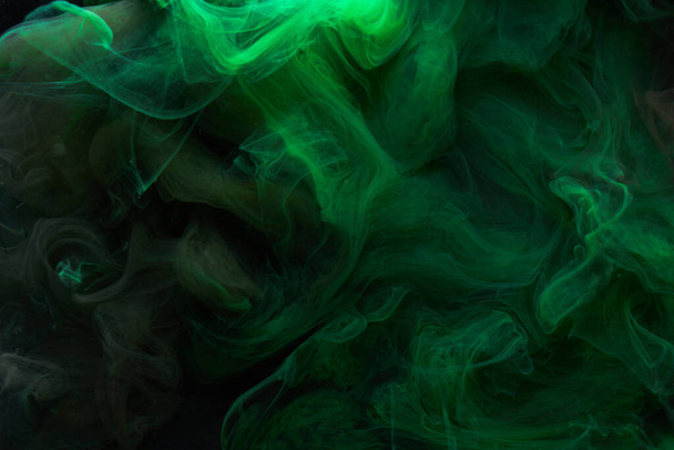 Black green smoke abstract background, acrylic paint underwater explosion, swirling ink - Фото, зображення