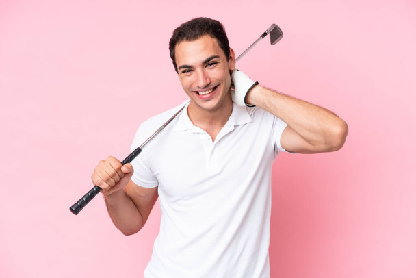 Young golfer player man isolated on pink background laughing - Photo, image