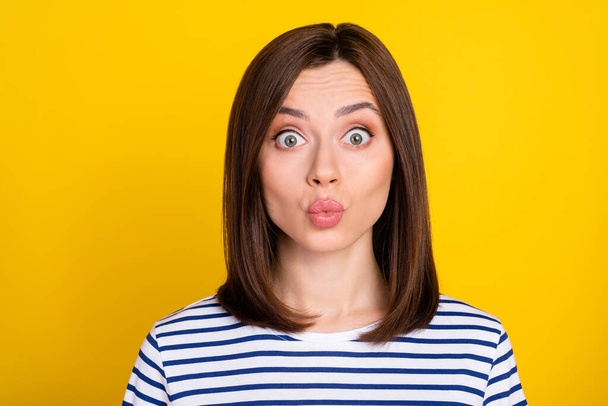 Photo of nice cute adorable girl with bob hairdo dressed striped t-shirt staring pouted lips kiss you isolated on yellow color background. - Foto, imagen