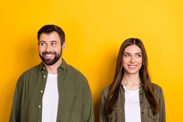 Portrait of two minded cheerful partners look empty space imagine isolated on yellow color background. - Φωτογραφία, εικόνα