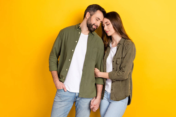 Portrait of attractive dreamy sweet cute couple bonding spending time harmony isolated over bright yellow color background. - Zdjęcie, obraz
