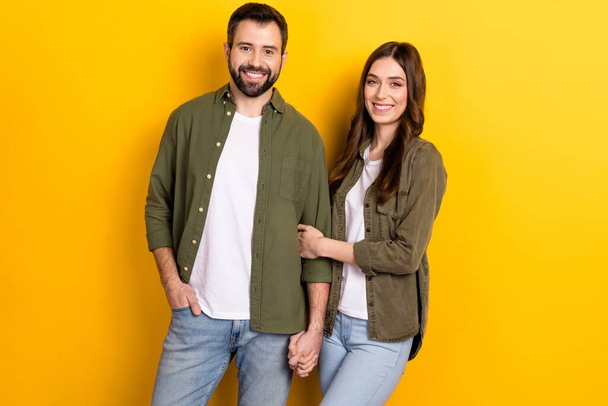 Photo of two cute people in relationship stand together wear matching clothes isolated on yellow color background. - 写真・画像