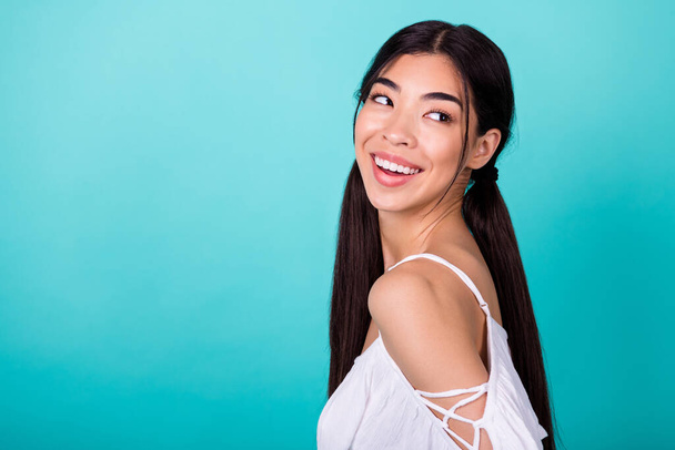 Profile photo of cheerful gorgeous vietnamee person look interested empty space isolated on cyan color background. - Foto, afbeelding
