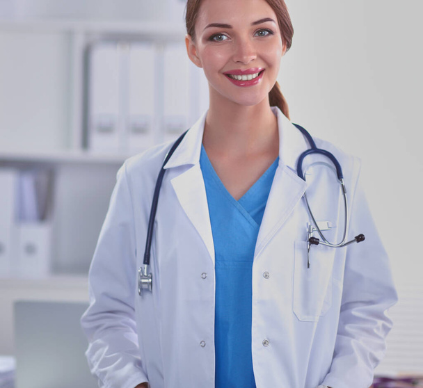 Portrait of successful young female doctor holding a stethoscope - Foto, immagini