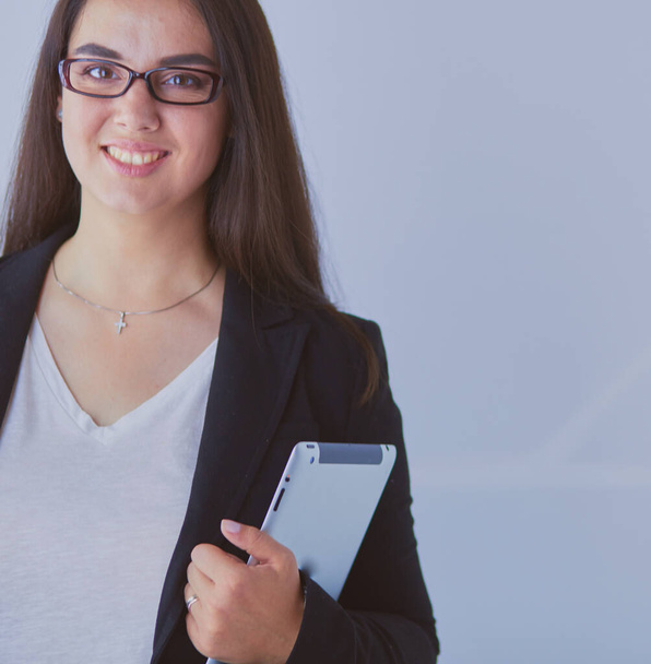 Portrait of smiling young business woman with digital tablet in her hands - Φωτογραφία, εικόνα