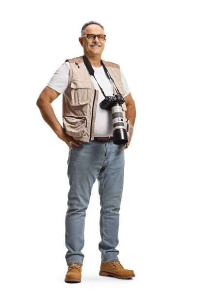 Full length portrait of a mature male photographer with a camera on a strap around neck isolated on white background - Fotografie, Obrázek