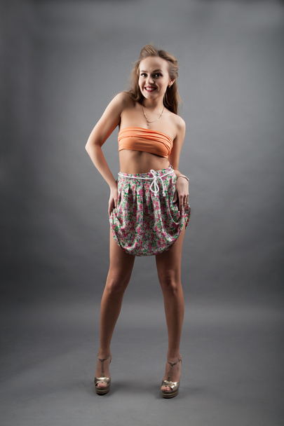 Girl in short skirt color. studio portrait - Фото, зображення