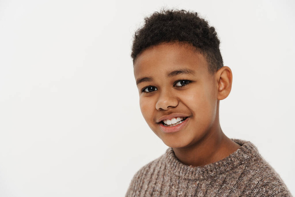 Black preteen boy wearing sweater smiling and looking at camera isolated over white background - Fotoğraf, Görsel