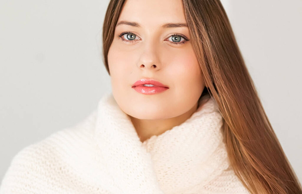 Autumn winter fashion and knitwear, beautiful woman wearing warm knitted scarf, close-up portrait - 写真・画像