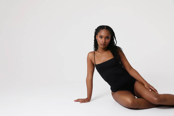 Gorgeous young woman wearing black bodysuit posing indoors. Isolated. mock-up. High quality photo. - Foto, Imagem