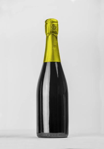 Champagnerflasche isoliert mit farbiger Kapuze für Etikettenkonzept und weitere Werkzeuge. Hochwertiges Foto - Foto, Bild