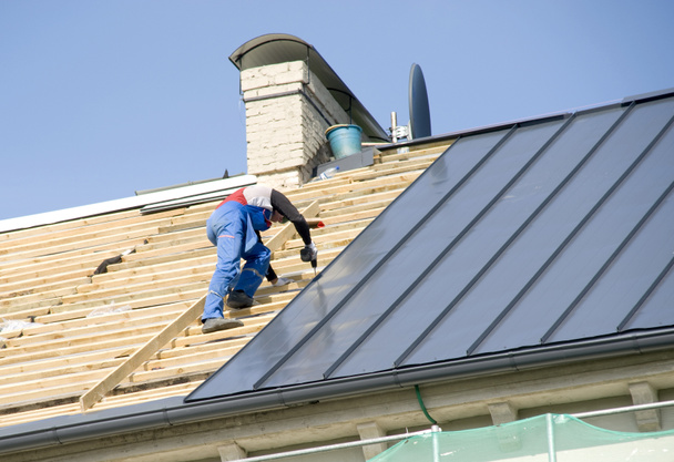 The roofer behind work on repair a roof - Photo, Image