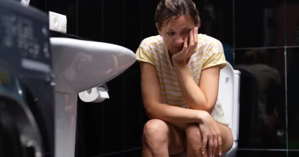 Frau ist nervös, leidet unter Durchfall und sitzt auf Toilette. Hämorrhoiden akute Symptome und Behandlung - Filmmaterial, Video