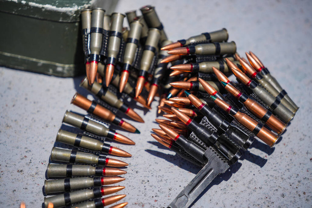 Close up shot of a machine gun belt loaded with cartridges. - Foto, Imagem