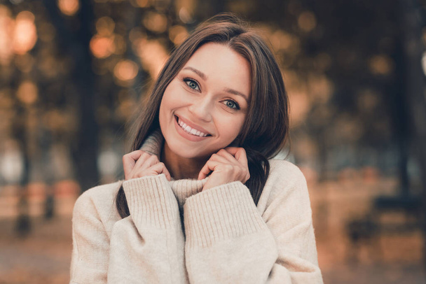 Portrait of pretty cheerful girl hands touch turtleneck collar beaming smile have good mood pastime outside. - Foto, imagen