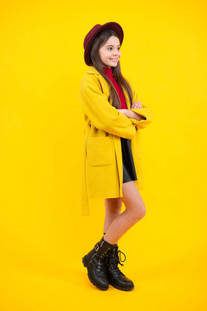 Autumn clothes. Full length of cheerful teenager child girl wearing comfy trendy fashion clothes, isolated over yellow background. Happy teenager portrait. Smiling girl - Фото, зображення