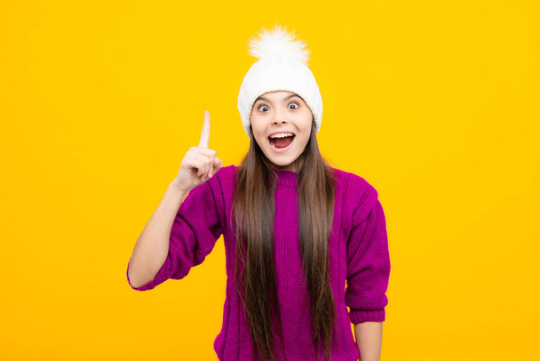 Excited face. School girl in winter clothes and warm hat. Winter holiday vacation. Child fashion model. Amazed expression, cheerful and glad - Foto, Imagen