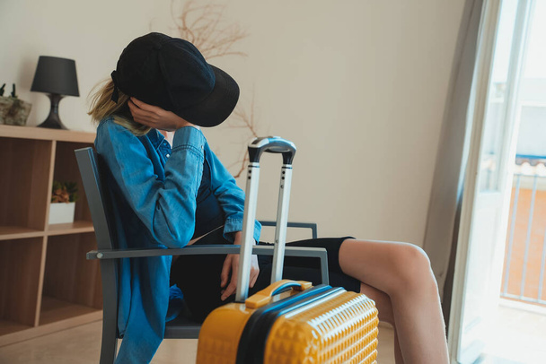Teenage girl got ready before everyone else and is waiting to go on vacation. - Photo, Image