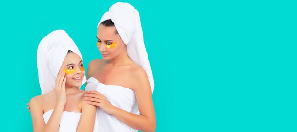 Mother and daughter child banner, copy space, isolated background. family spa of mother and daughter with facial patch - Photo, Image