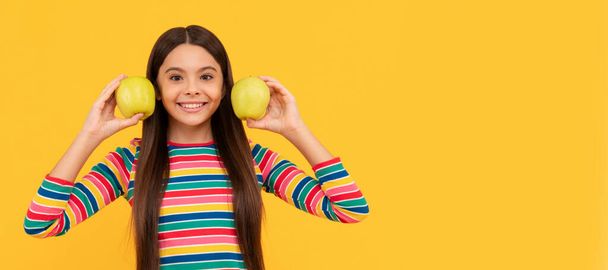 Say hello to a nice smile. Happy child smile holding apples. Child girl portrait with apple, horizontal poster. Banner header with copy space - Photo, image