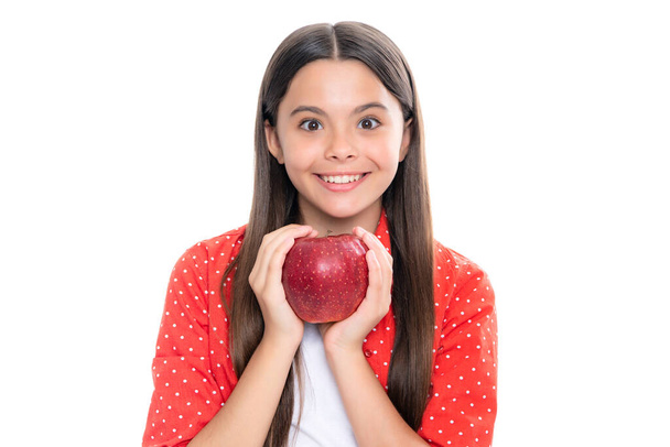 Teenager child with apple on yellow isolated background. apples are good for children. Portrait of happy smiling teenage child girl - Foto, imagen
