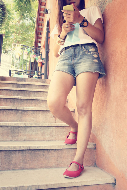 woman leg and shoes with smartphone - Φωτογραφία, εικόνα