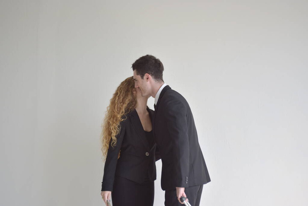 portrait of beautiful business couple in formal clothes posing in a studio. - Фото, зображення