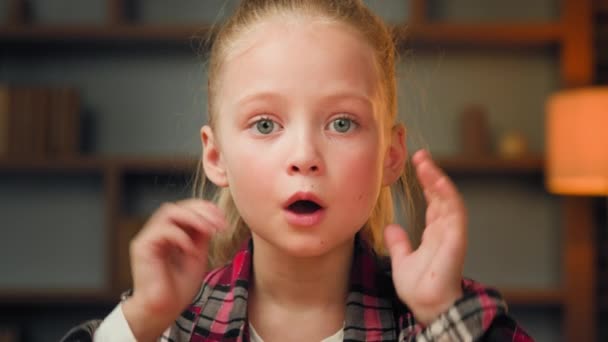 Portrait surprised caucasian teen girl shocked joyful kid with amazement on face by unexpected good news look at camera touch head happy cute small blonde child preschooler receive surprise say wow - Footage, Video