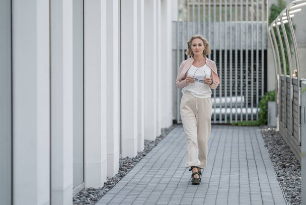 Retrato de mulher adulta branca branca bonita Ela está vestindo estilo de vida ativo ao ar livre Sportwear. Vilnius, Lituânia. T-shirt branca. - Foto, Imagem