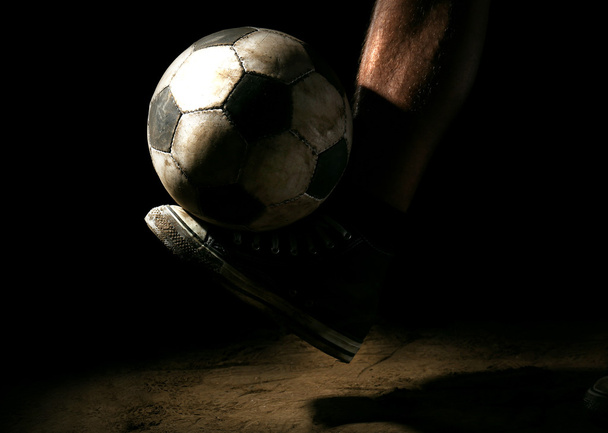 Soccer ball on ground on dark background - Фото, изображение